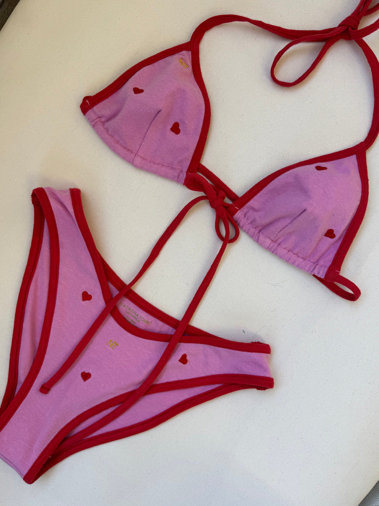 PINK BIKINI WITH RED BORDER AND HEARTS IN RED.